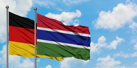 Germany and Gambia flag waving in the wind against white cloudy blue sky together. Diplomacy concept, international relations.