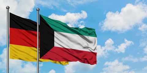 Germany and Kuwait flag waving in the wind against white cloudy blue sky together. Diplomacy concept, international relations.