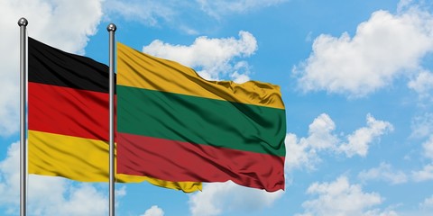 Germany and Lithuania flag waving in the wind against white cloudy blue sky together. Diplomacy concept, international relations.