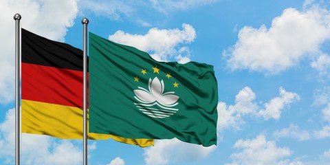 Germany and Macao flag waving in the wind against white cloudy blue sky together. Diplomacy concept, international relations.