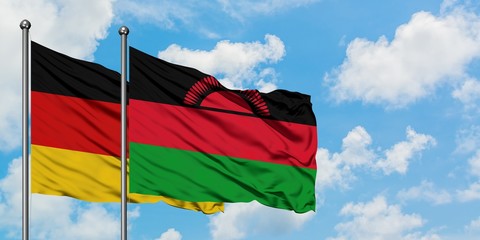 Germany and Malawi flag waving in the wind against white cloudy blue sky together. Diplomacy concept, international relations.