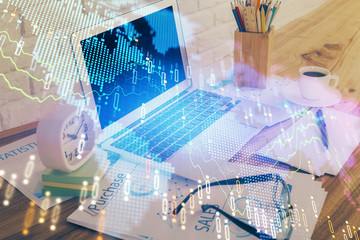 Stock market graph and table with computer background. Double exposure. Concept of financial analysis.