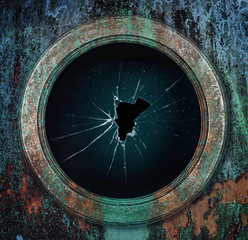 A Vintage rusty porthole with broken glass