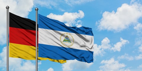 Germany and Nicaragua flag waving in the wind against white cloudy blue sky together. Diplomacy concept, international relations.