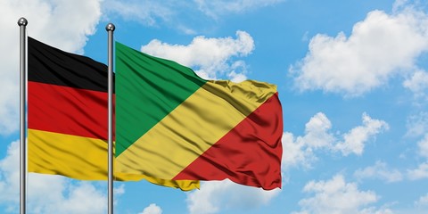 Germany and Republic Of The Congo flag waving in the wind against white cloudy blue sky together. Diplomacy concept, international relations.