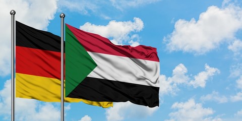 Germany and Sudan flag waving in the wind against white cloudy blue sky together. Diplomacy concept, international relations.