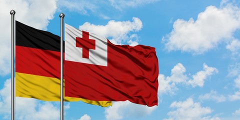 Germany and Tonga flag waving in the wind against white cloudy blue sky together. Diplomacy concept, international relations.