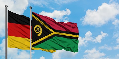 Germany and Vanuatu flag waving in the wind against white cloudy blue sky together. Diplomacy concept, international relations.