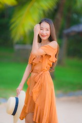 Portrait beautiful young asian woman happy smile relax on the beach sea ocean