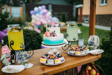 Cake with berries and fruits on a festively decorated table