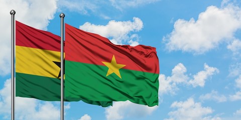 Ghana and Burkina Faso flag waving in the wind against white cloudy blue sky together. Diplomacy concept, international relations.