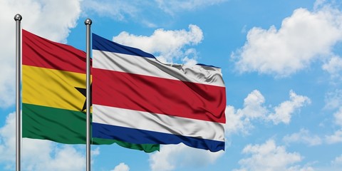 Ghana and Costa Rica flag waving in the wind against white cloudy blue sky together. Diplomacy concept, international relations.