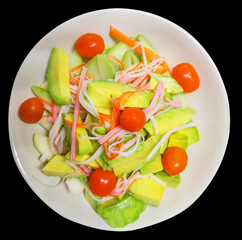 Healthy Fresh salad with green oak, tomato, Crab stick, Avocado in white bowl on black background on top view