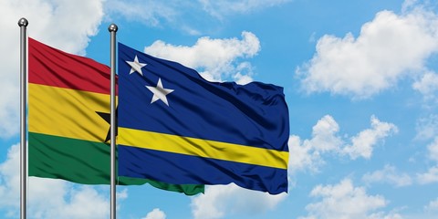 Ghana and Curacao flag waving in the wind against white cloudy blue sky together. Diplomacy concept, international relations.