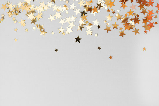Abstract Christmas background with golden glitter over white board. © Inga