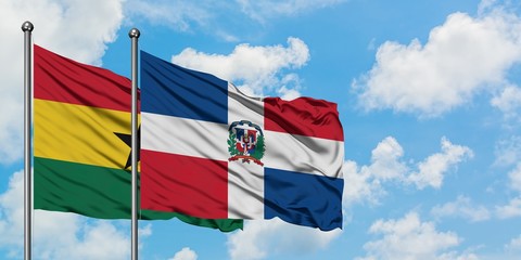 Ghana and Dominican Republic flag waving in the wind against white cloudy blue sky together. Diplomacy concept, international relations.
