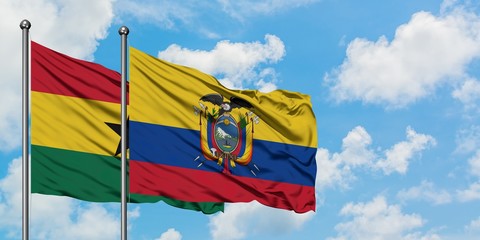 Ghana and Ecuador flag waving in the wind against white cloudy blue sky together. Diplomacy...
