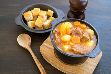 thick Hungarian soup, the goulash. on dark background.