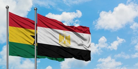 Ghana and Egypt flag waving in the wind against white cloudy blue sky together. Diplomacy concept, international relations.