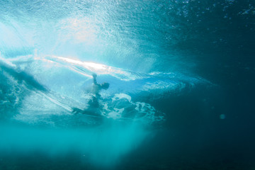 Underwater surf photography, surfer riding the wave