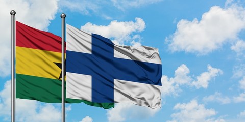 Ghana and Finland flag waving in the wind against white cloudy blue sky together. Diplomacy...