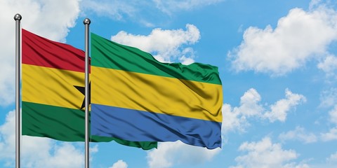 Ghana and Gabon flag waving in the wind against white cloudy blue sky together. Diplomacy concept,...