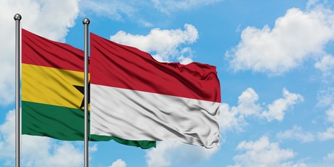Ghana and Indonesia flag waving in the wind against white cloudy blue sky together. Diplomacy concept, international relations.