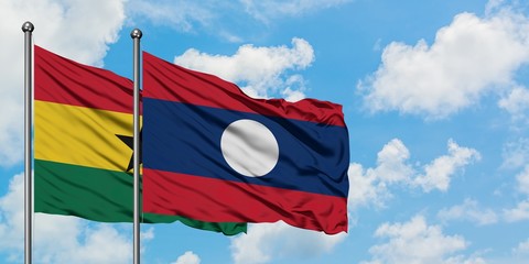 Ghana and Laos flag waving in the wind against white cloudy blue sky together. Diplomacy concept,...