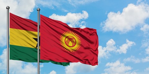 Ghana and Kyrgyzstan flag waving in the wind against white cloudy blue sky together. Diplomacy concept, international relations.