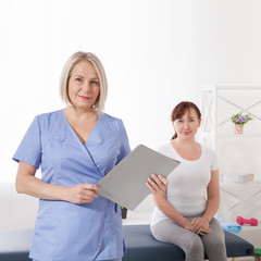 Female patient being reassured by doctor in hospital.