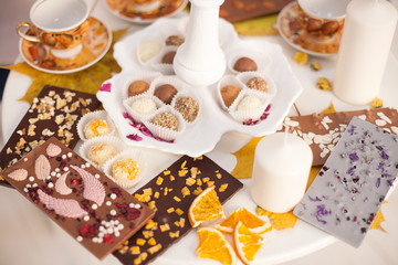 a Cup of tea on the table with desserts. an abundance of sweets and delicious handmade sweets. celebration and tea party. The view from the top, Flatley. chocolate with nuts and marzipans