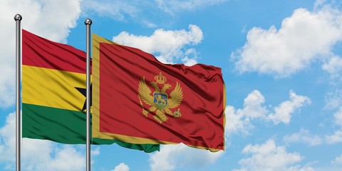 Ghana and Montenegro flag waving in the wind against white cloudy blue sky together. Diplomacy concept, international relations.