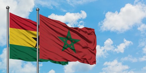 Ghana and Morocco flag waving in the wind against white cloudy blue sky together. Diplomacy concept, international relations.