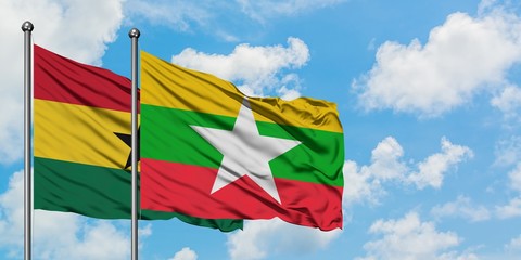 Ghana and Myanmar flag waving in the wind against white cloudy blue sky together. Diplomacy concept, international relations.