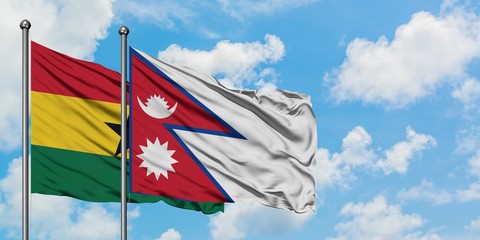 Ghana and Nepal flag waving in the wind against white cloudy blue sky together. Diplomacy concept, international relations.