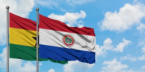 Ghana and Paraguay flag waving in the wind against white cloudy blue sky together. Diplomacy concept, international relations.