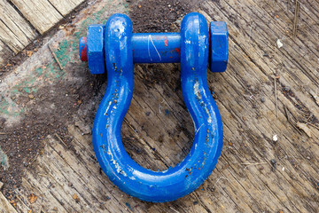 Shackle painted blue and laid on deck of a construction barge
