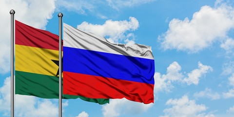 Ghana and Russia flag waving in the wind against white cloudy blue sky together. Diplomacy concept, international relations.