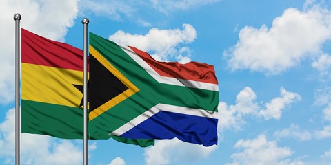 Ghana and South Africa flag waving in the wind against white cloudy blue sky together. Diplomacy concept, international relations.