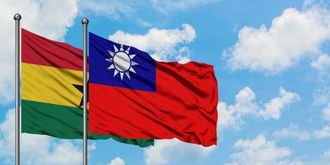 Ghana and Taiwan flag waving in the wind against white cloudy blue sky together. Diplomacy concept, international relations.