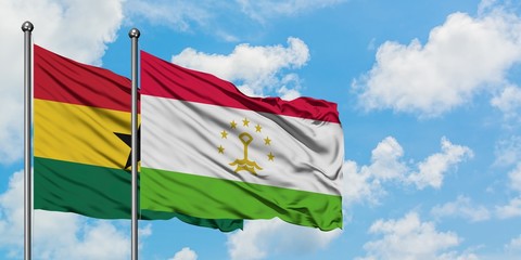 Ghana and Tajikistan flag waving in the wind against white cloudy blue sky together. Diplomacy concept, international relations.