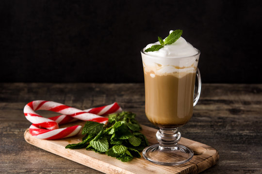 Peppermint coffee mocha for Christmas on wooden table. Copy space	