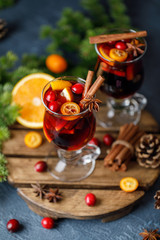 Christmas mulled red wine with spices, cranberry and fruits. Traditional Christmas hot drink. Christmas drink background