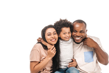 happy african american boy hugging parents and smiling at camera isolated on white