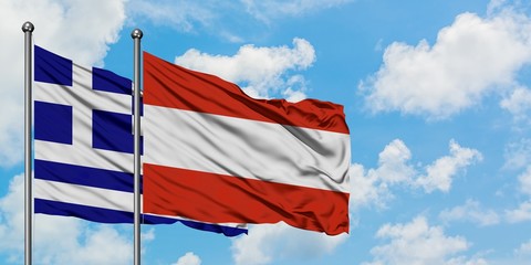 Greece and Austria flag waving in the wind against white cloudy blue sky together. Diplomacy concept, international relations.