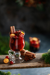 Christmas mulled red wine with spices, cranberry and fruits. Traditional Christmas hot drink. Christmas drink background