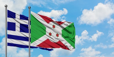 Greece and Burundi flag waving in the wind against white cloudy blue sky together. Diplomacy...
