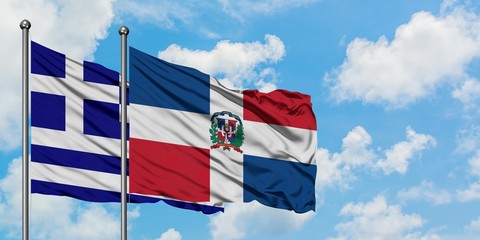 Greece and Dominican Republic flag waving in the wind against white cloudy blue sky together. Diplomacy concept, international relations.