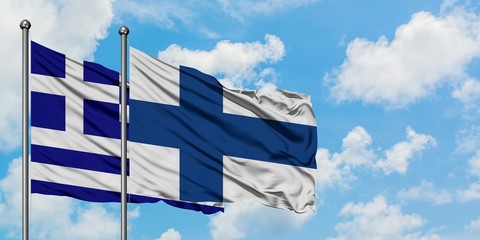 Greece and Finland flag waving in the wind against white cloudy blue sky together. Diplomacy concept, international relations.
