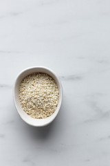 Sesame seeds on marble background with copy space